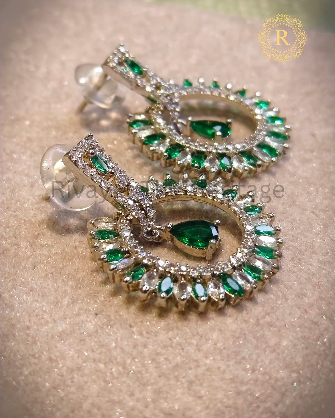 Green zircon diamond earrings showing rhodium-finish floral halo design – close-up angle