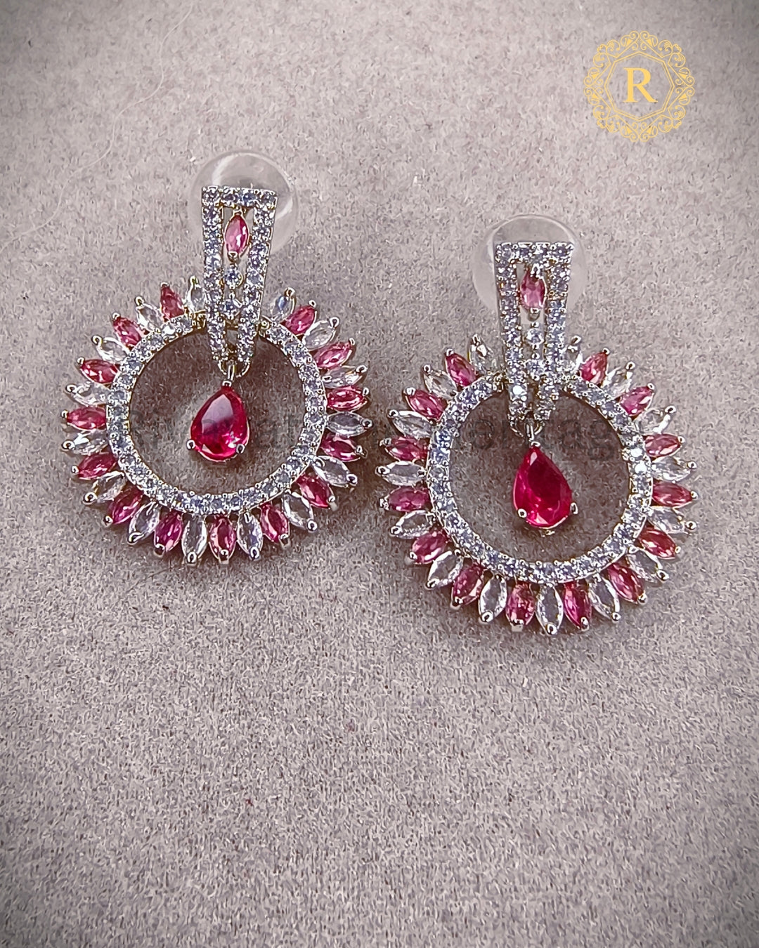 Pink zircon halo drop earrings with pear-cut center stone, close-up view