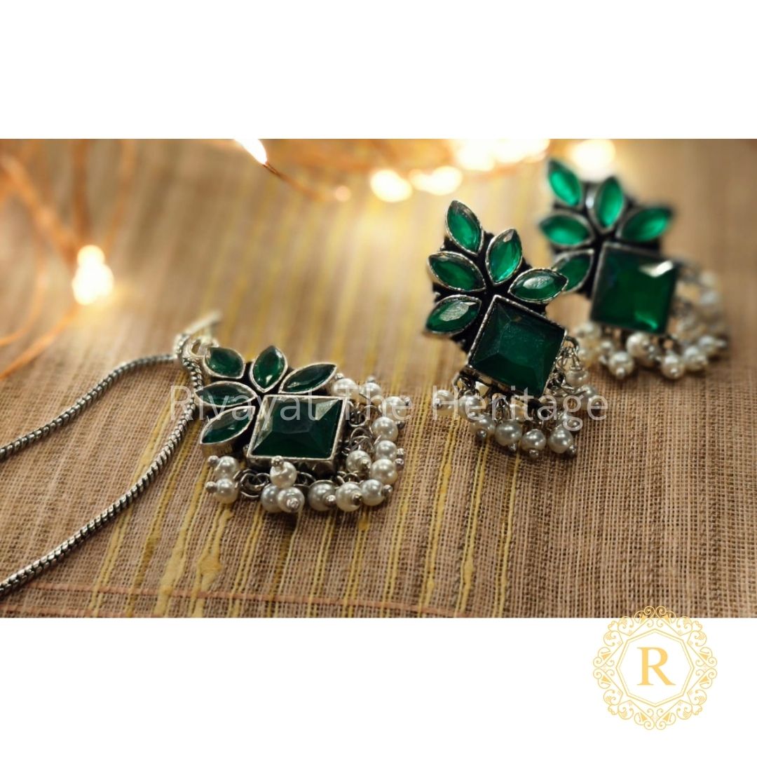 Emerald green oxidized German silver jewelry set with leaf design and Monalisa stones featuring matching earrings and pendant with pearl clusters by Rivayat Heritage