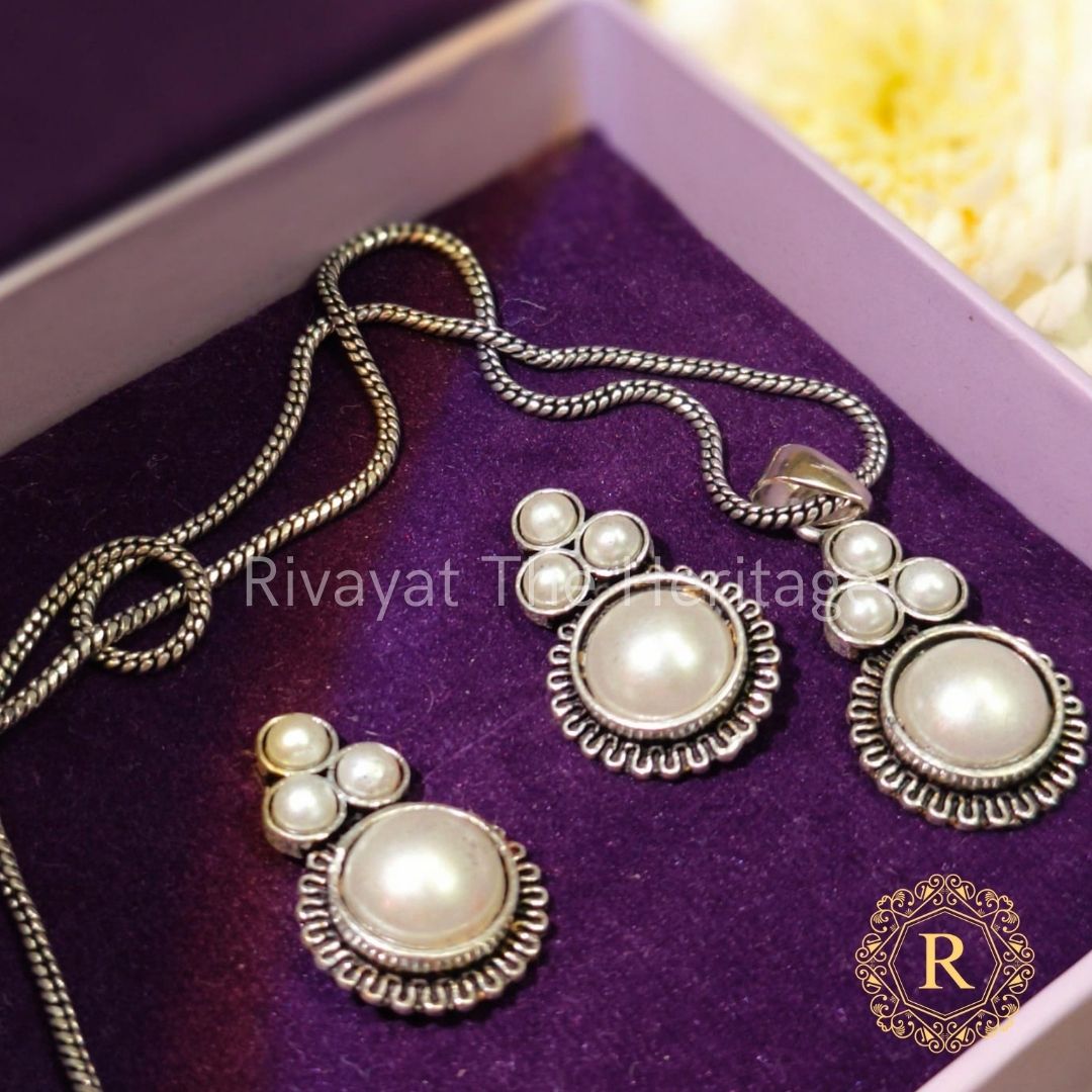 Handcrafted German silver jewelry set with cream Monalisa stones featuring pendant necklace and matching earrings in purple velvet box