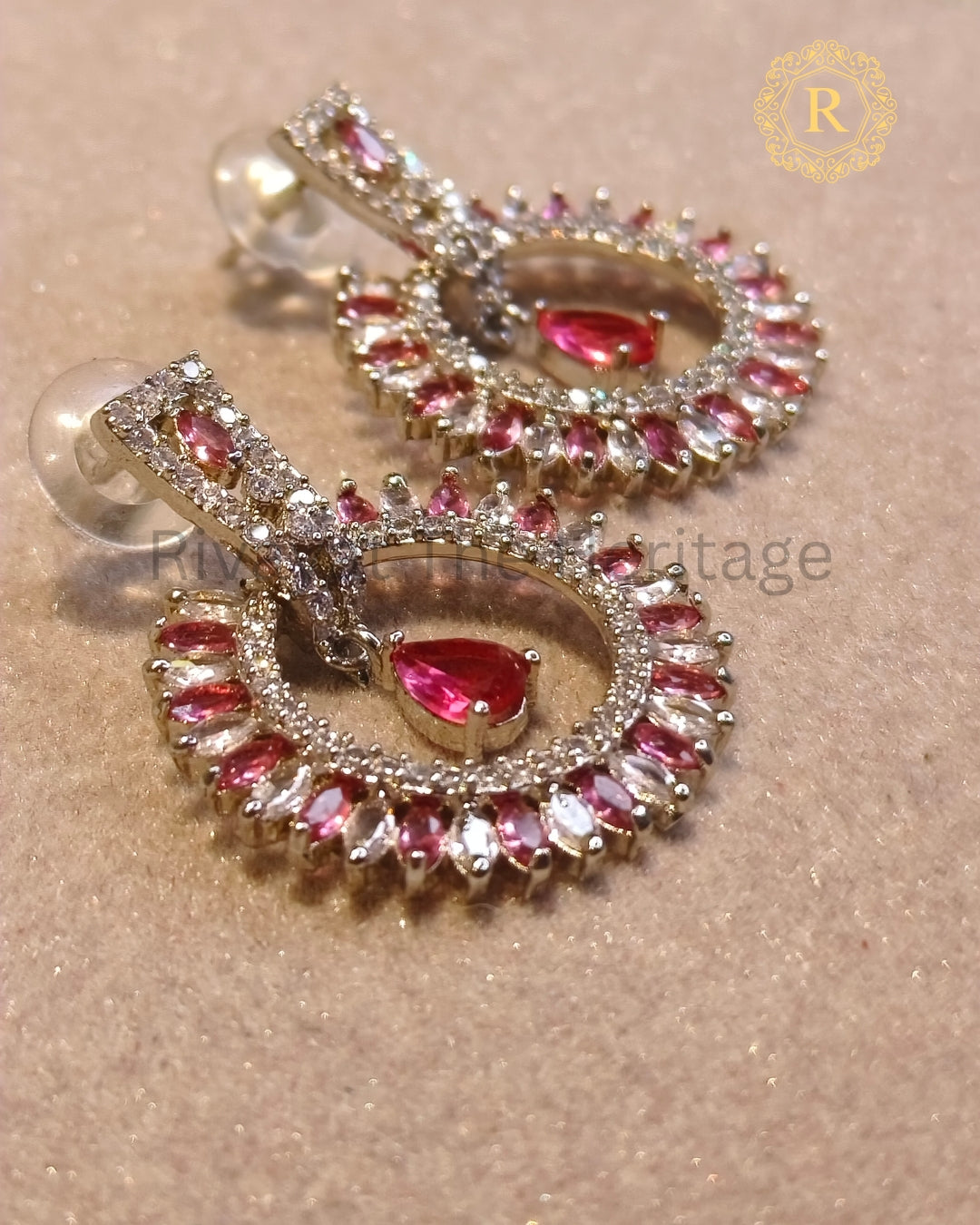 Silver-tone pink zircon earrings, front view showing halo design
