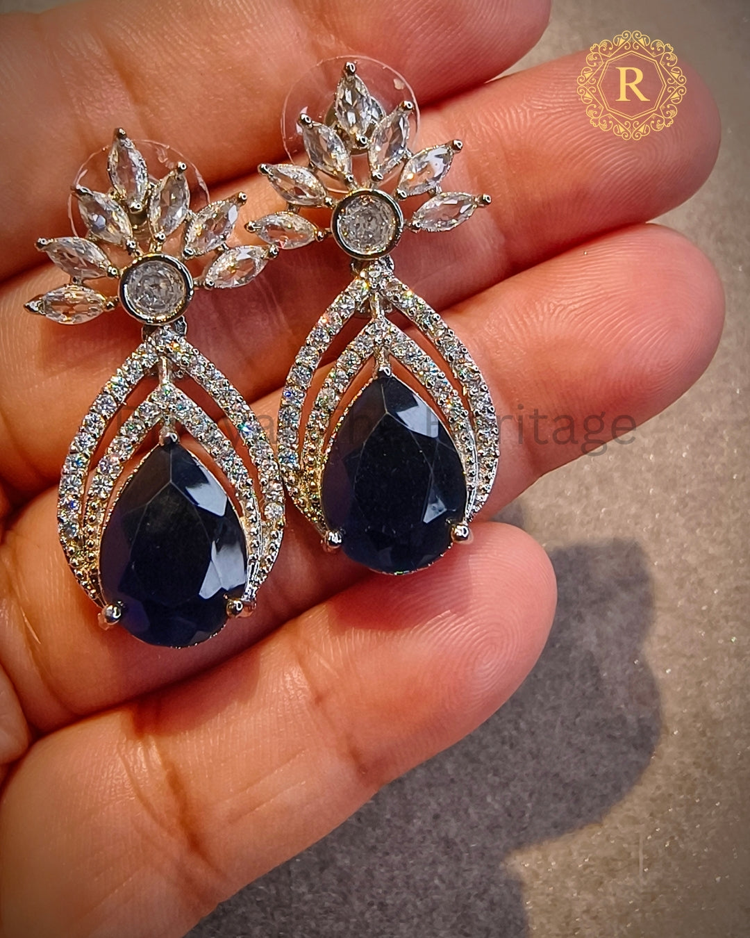 Close-up of royal blue zircon diamond earrings with marquise cut stones
