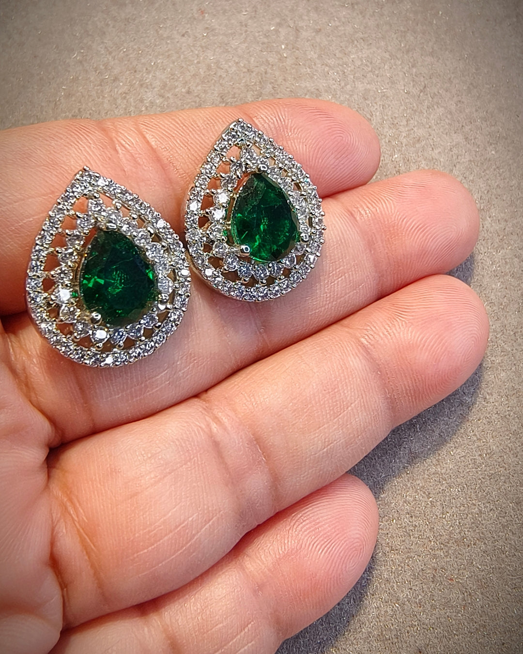 Green zircon teardrop earrings with sparkling zircon detailing in a silver-tone setting
