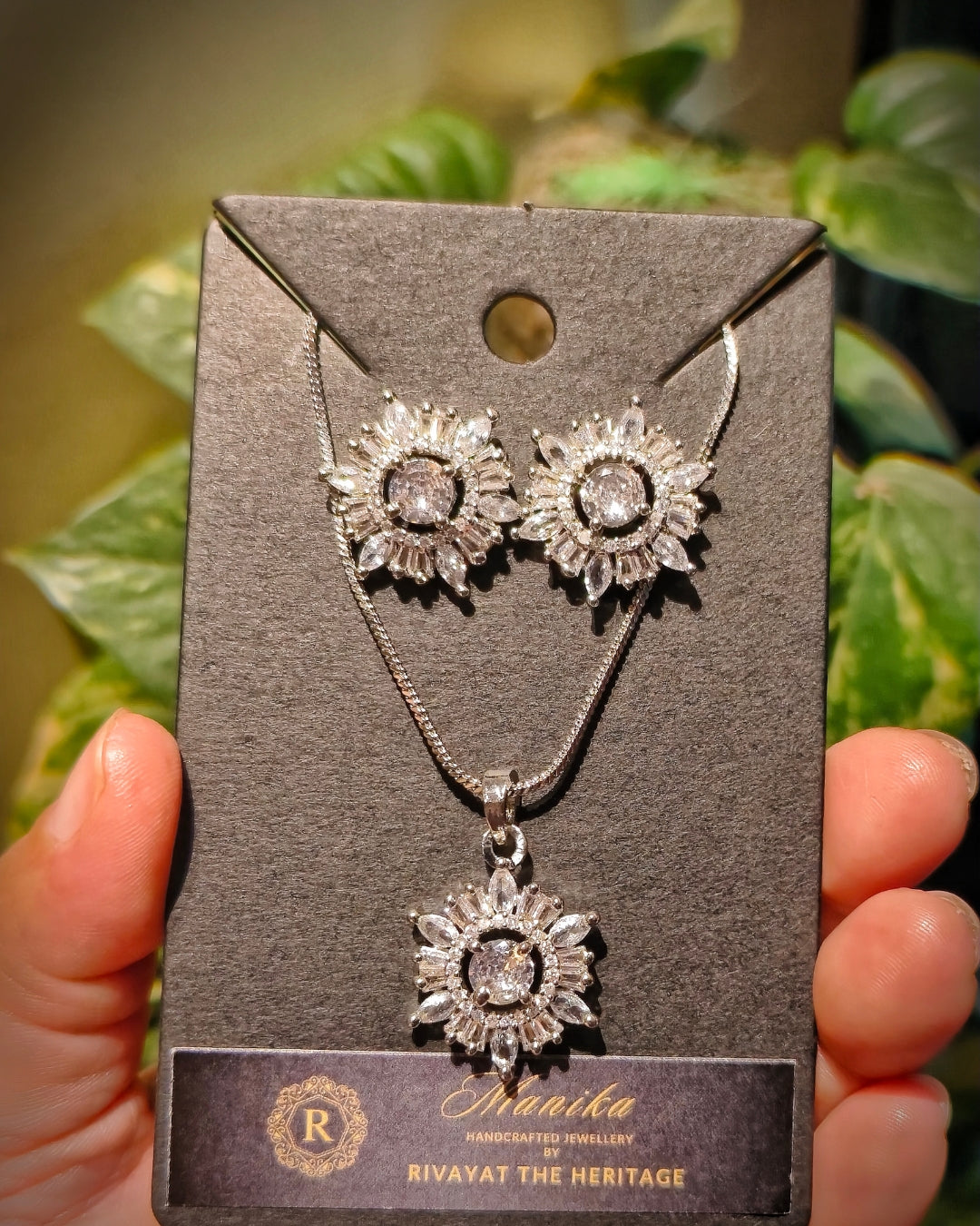 Floral zircon necklace set with matching earrings showing clear sparkling stones and silver-tone finish