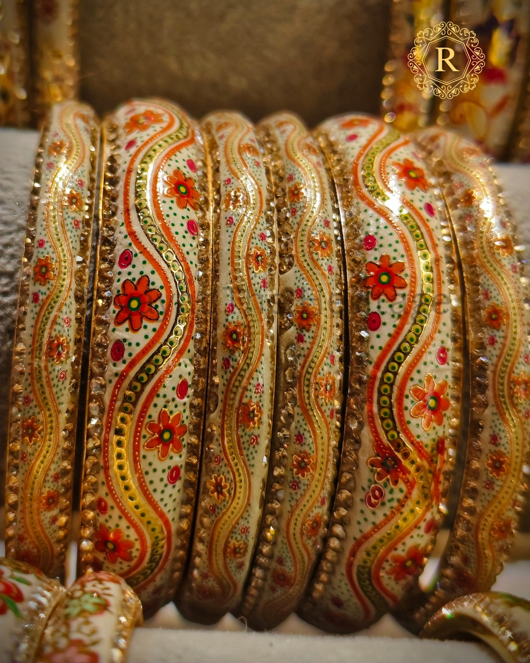 Handpainted Meenakari bangles with orange floral enamel work and kundan border