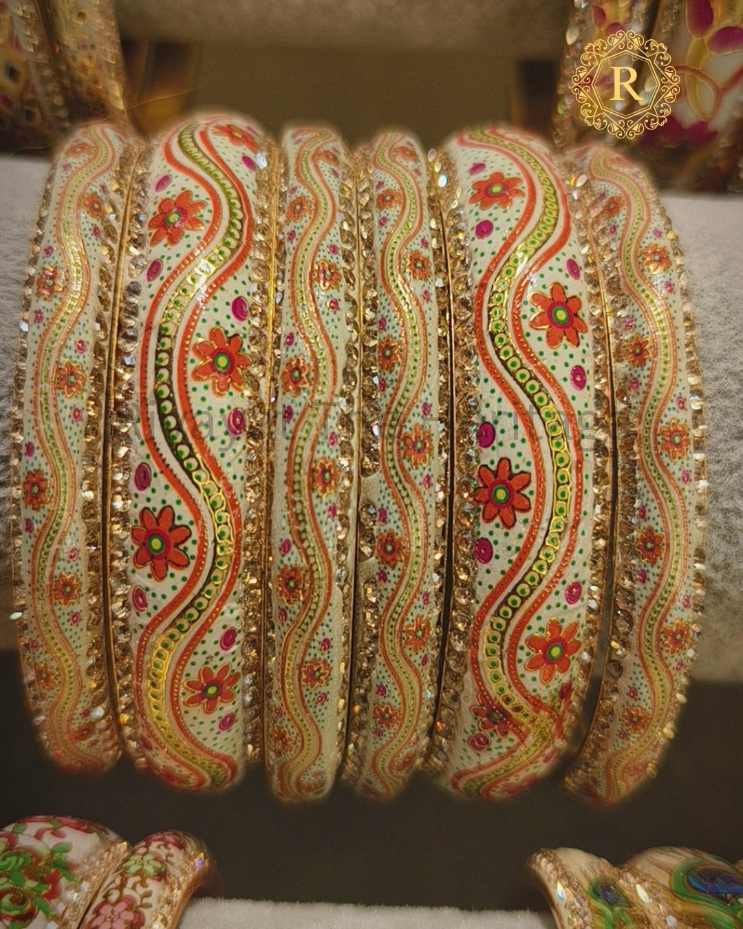 Close-up of cream Meenakari bangle set showing intricate floral and vine detailing