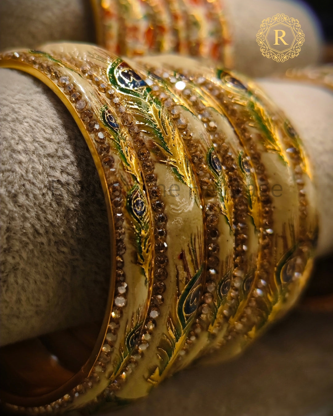Ivory Meenakari bangle set with peacock enamel work displayed on jewellery stand