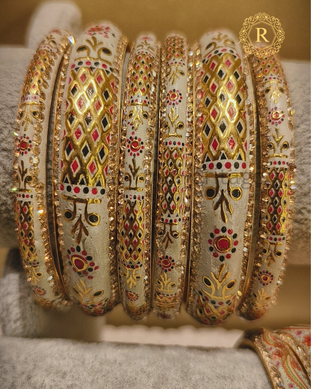 Macro shot of stone-studded border and peacock motif on Meenakari bangle