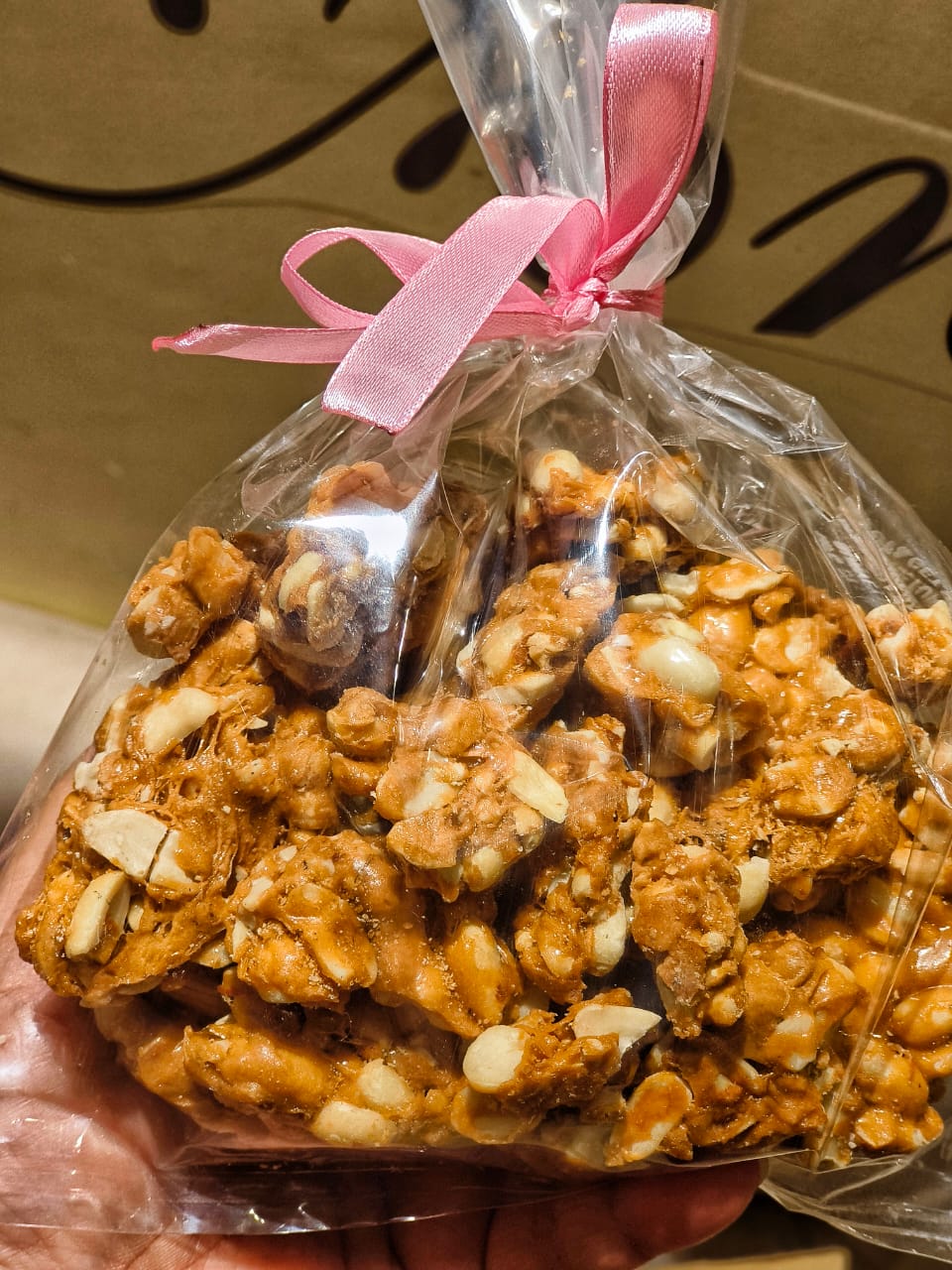 Traditional Indian jaggery peanut gachak gift packed with pink ribbon - artisan winter sweet from Rivayat The Heritage