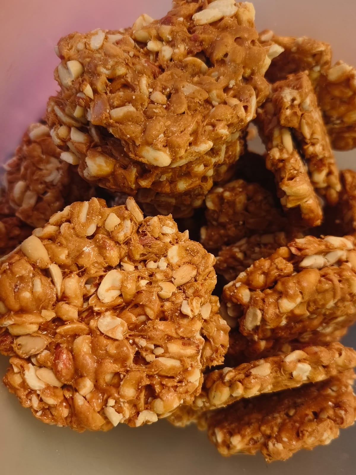 Close-up of premium soft desi gud gachak with roasted peanuts showing authentic texture and natural jaggery coating