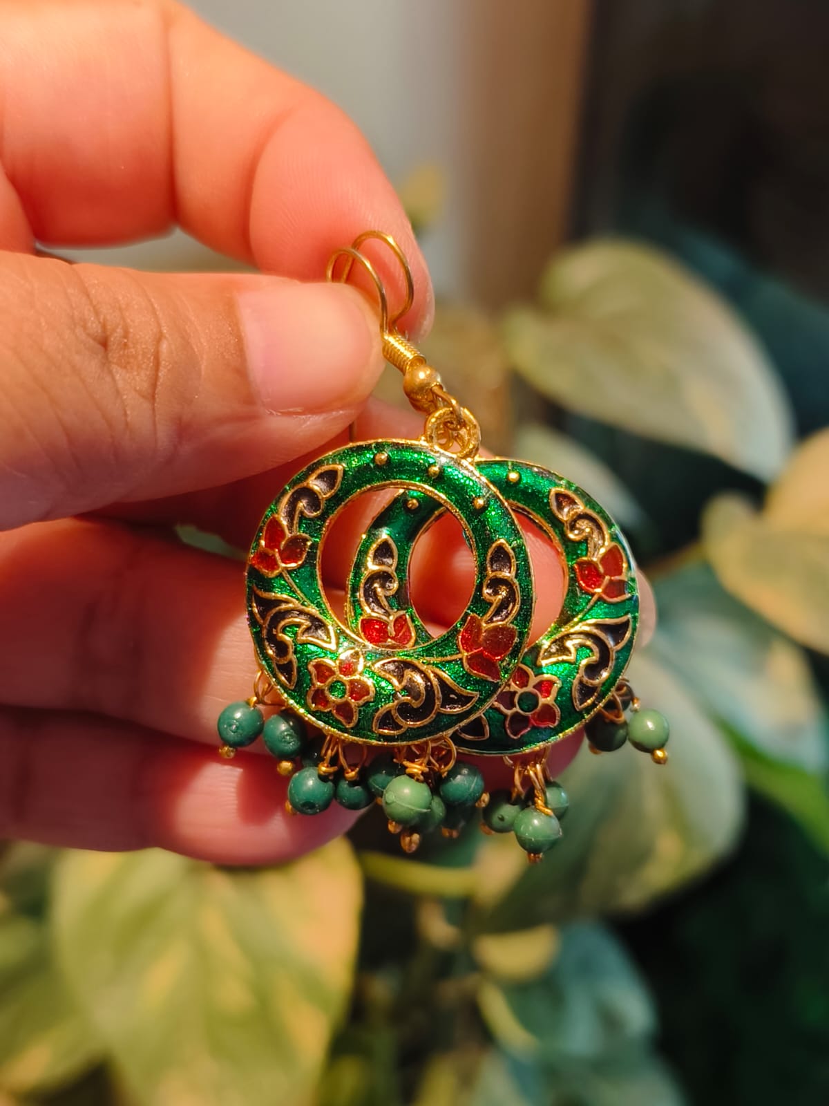 Handcrafted Meenakari green chandbali earring with red floral enamel work, gold outline, and teal bead drops — Rivayat Manika Collection
