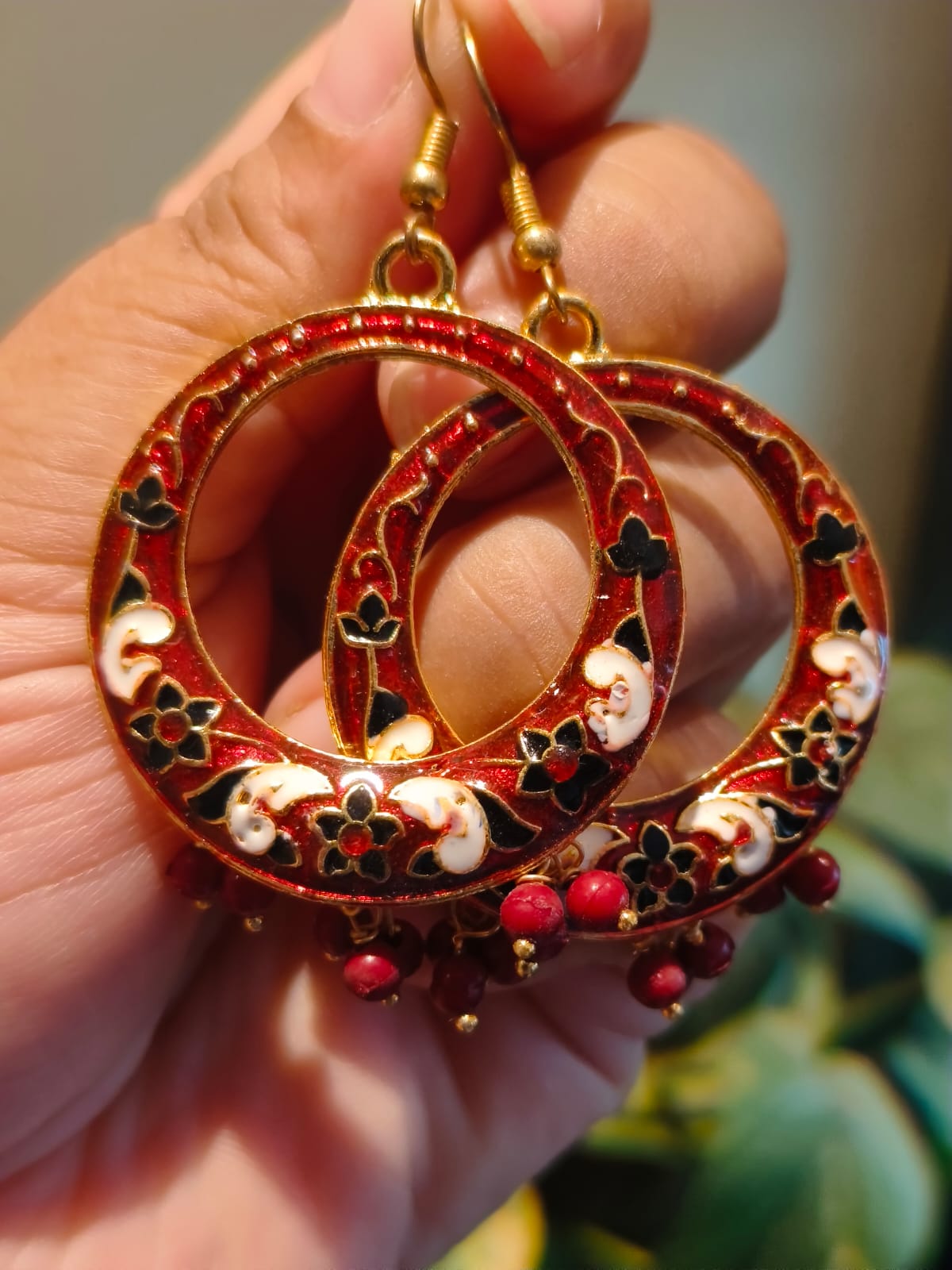 Handmade red Meenakari hoop earrings with gold base, black floral enamel and red bead drops — Rivayat Manika Collection