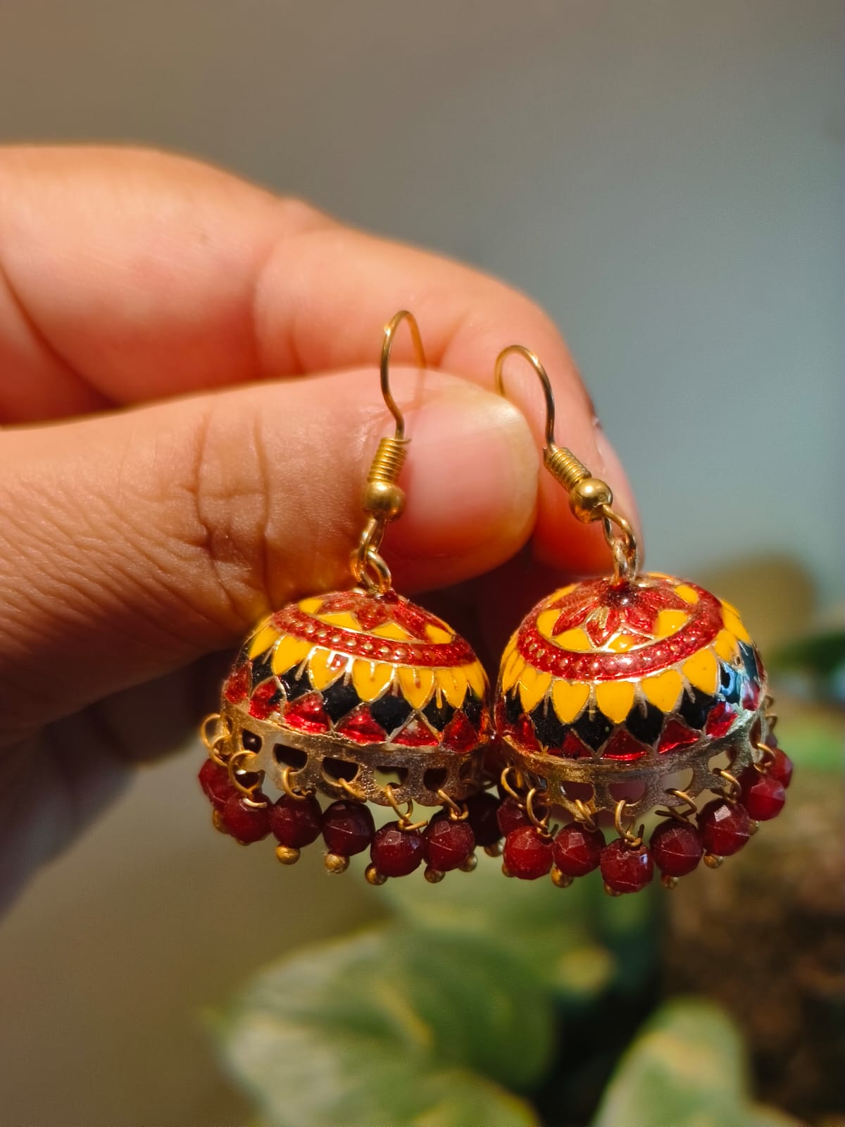 Meenakari Jhumki earrings with gold dome, red floral enamel work and deep red crystal bead drops – Rivayat