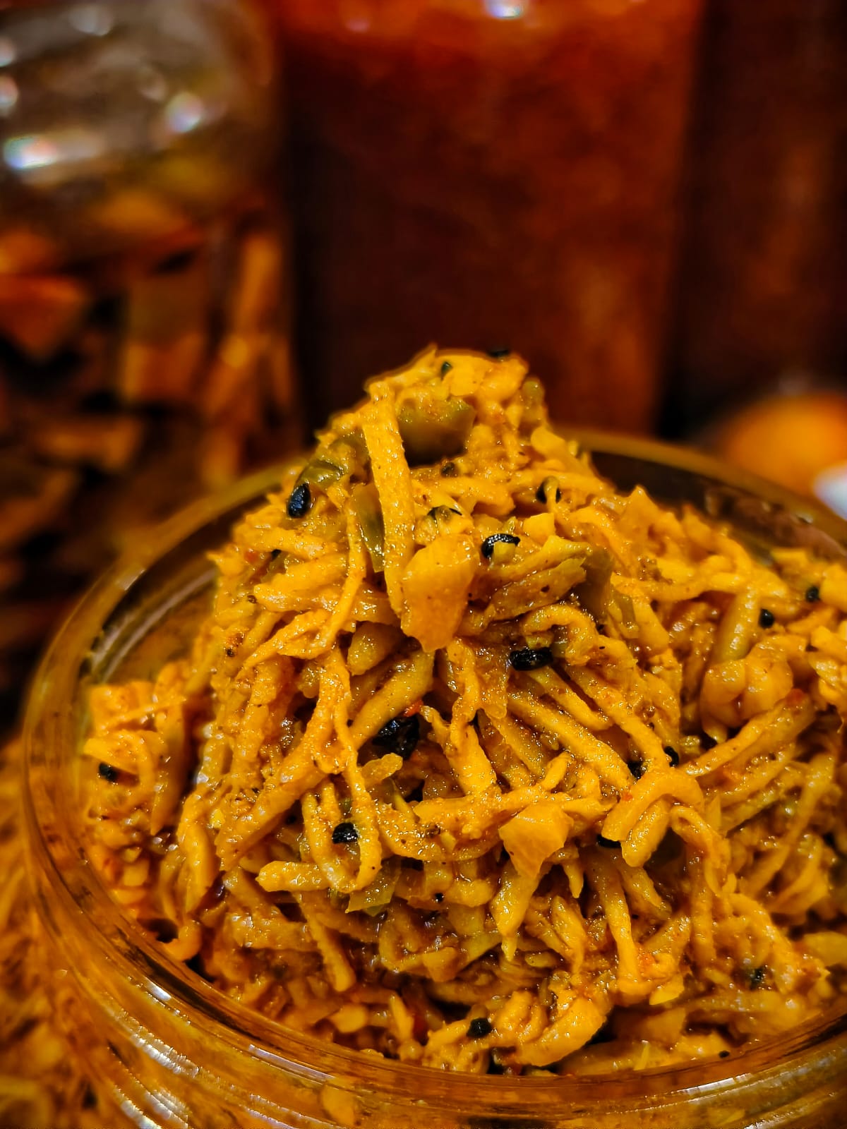 Close-up of grated authentic Punjabi Mango Chilli Garlic Pickle showing natural spices and rich texture.