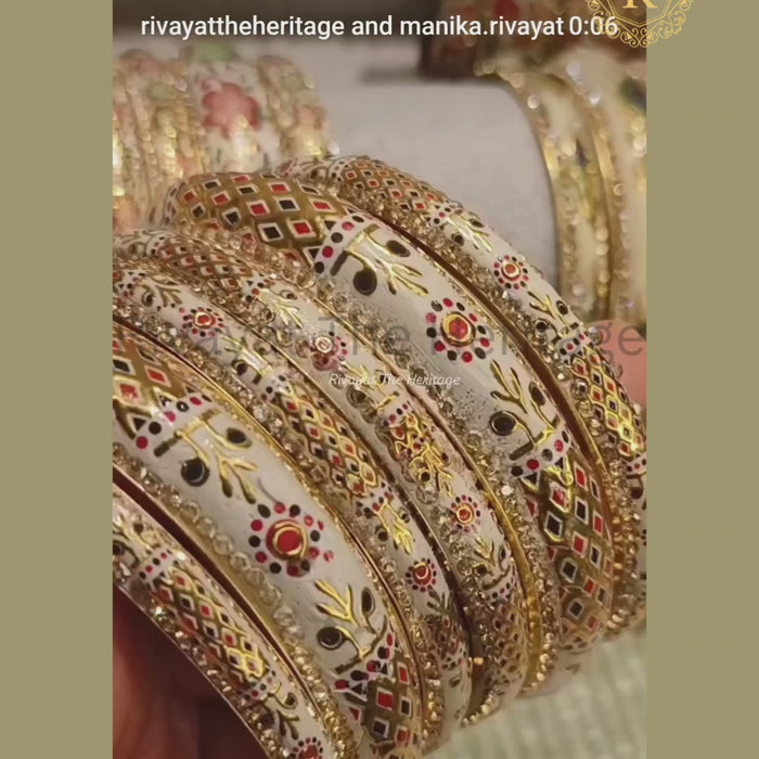 Ivory Meenakari peacock bangles set with stone-studded borders, handcrafted enamel jewellery from Rivayat The Heritage