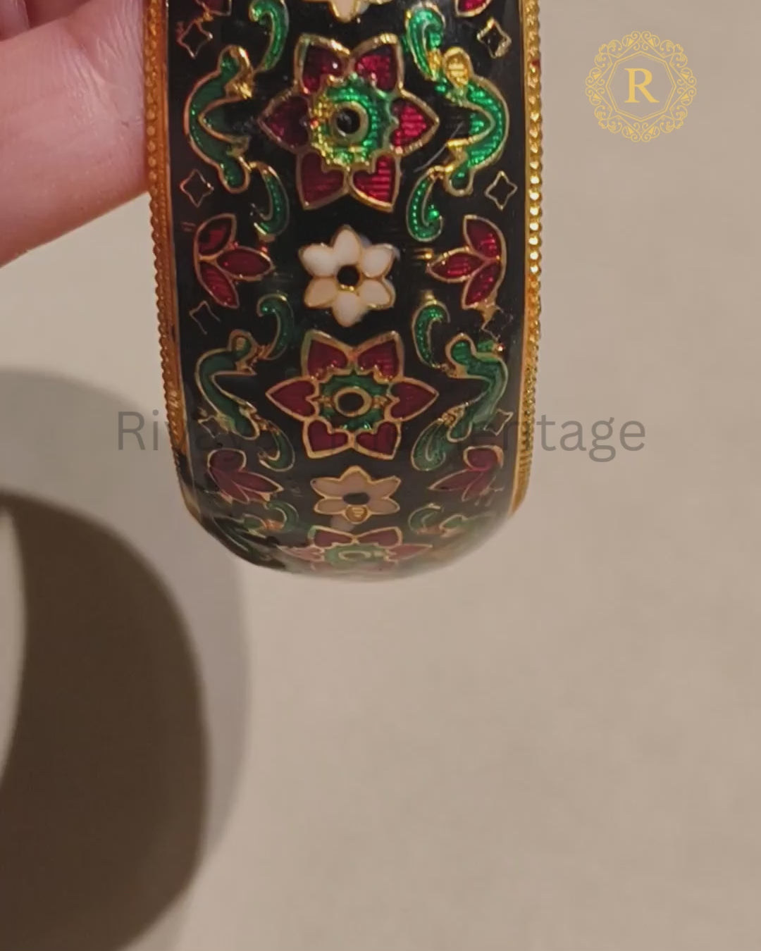 Black Meenakari kada with colourful floral motifs, enamel detailing and gold-tone finish