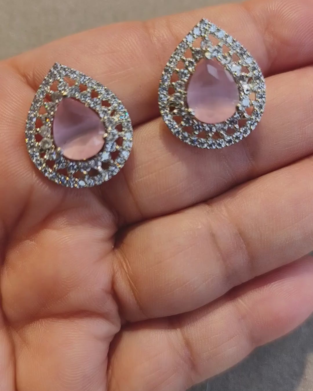 Pink stone zircon diamond earrings showing sparkling clear zircon stones and silver-tone teardrop design