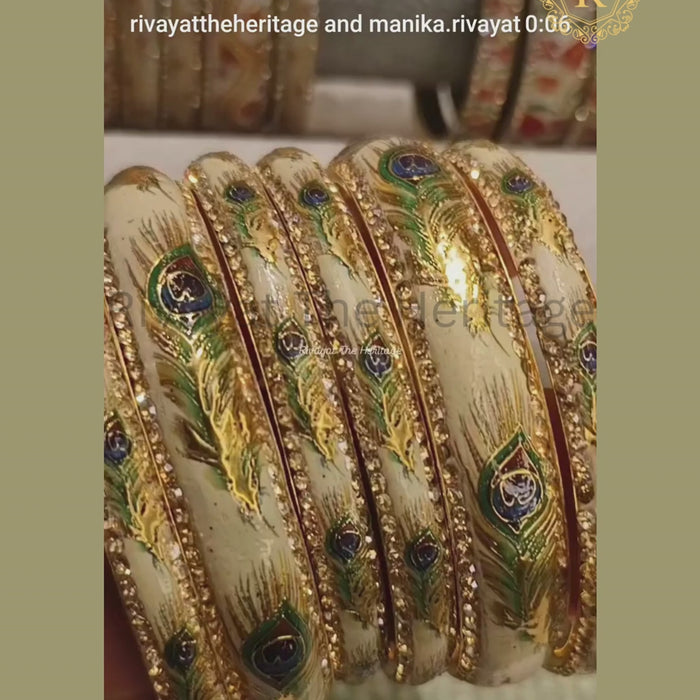 Video showcasing ivory Meenakari bangles with peacock feather enamel work and stone-studded borders from every angle