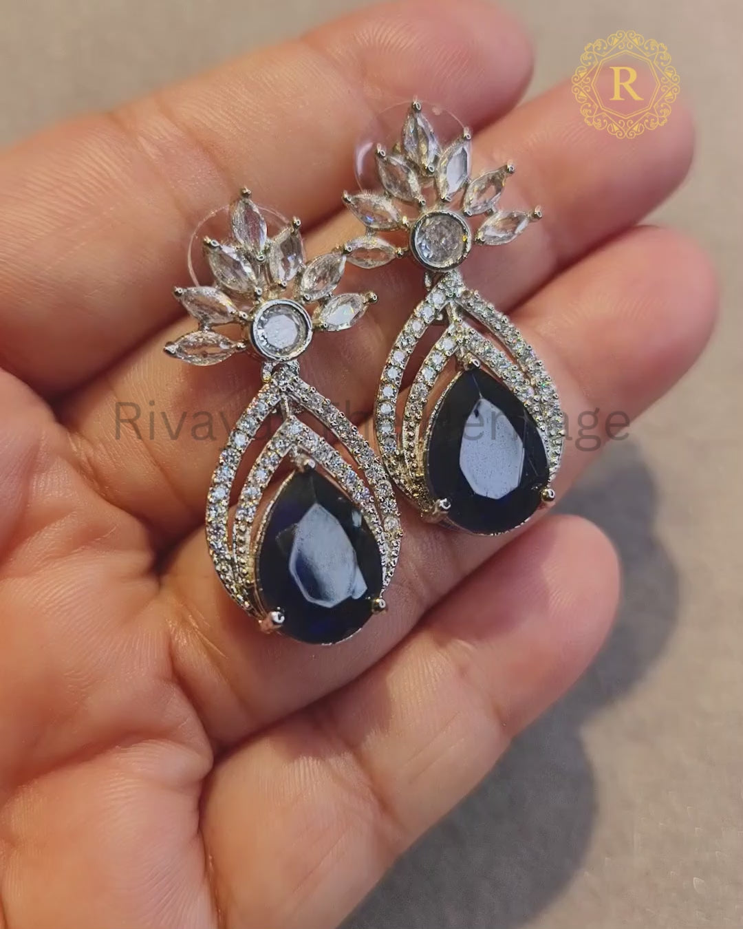 Video showcasing royal blue zircon diamond pear drop earrings sparkle and movement