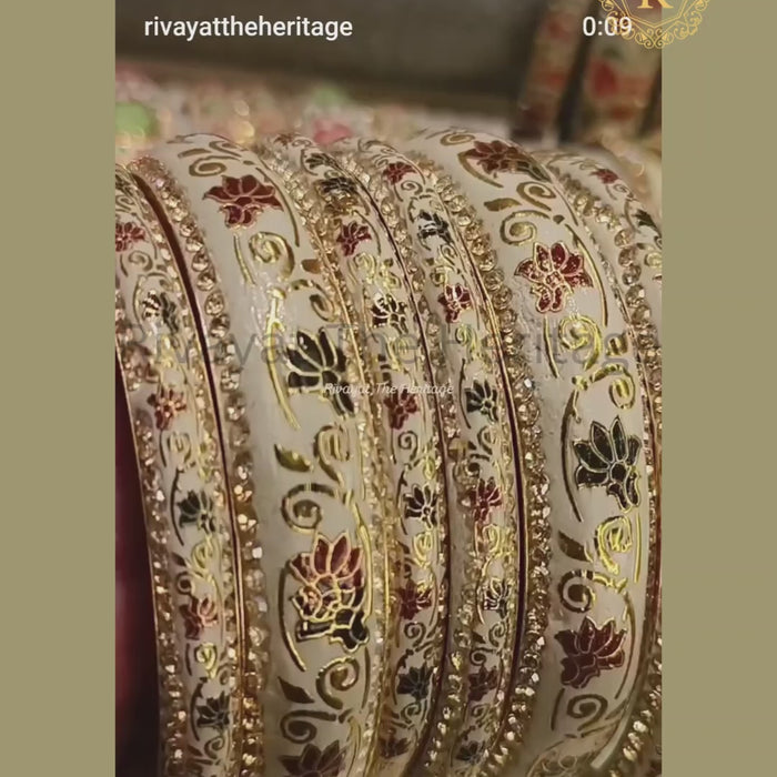 Ivory meenakari lotus bangles displayed in motion showing enamel detailing and stone sparkle