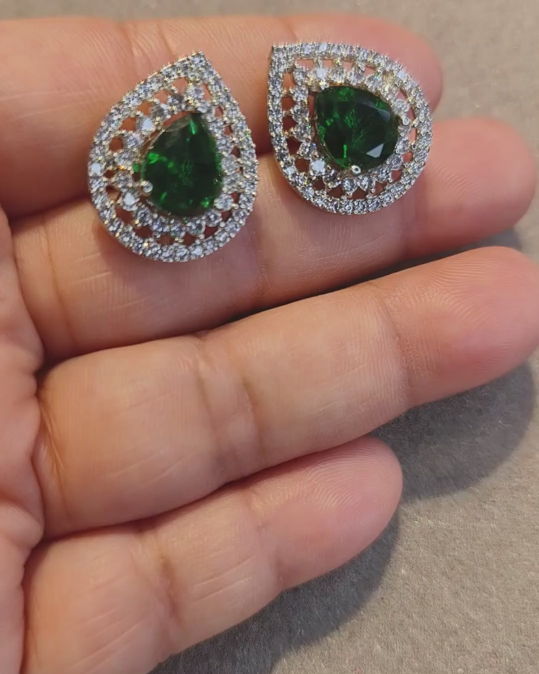 Green zircon teardrop earrings showcasing the green centre stone and sparkling zircon detailing