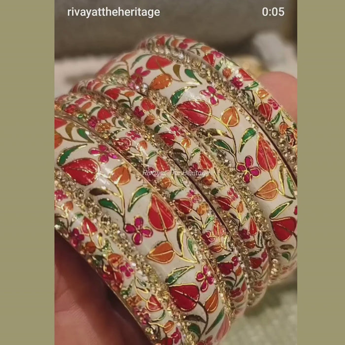 Video showcasing white Meenakari bangle set with floral enamel work and gold detailing from multiple angles
