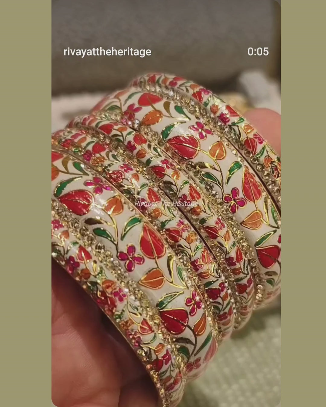 Video showcasing white Meenakari bangle set with floral enamel work and gold detailing from multiple angles