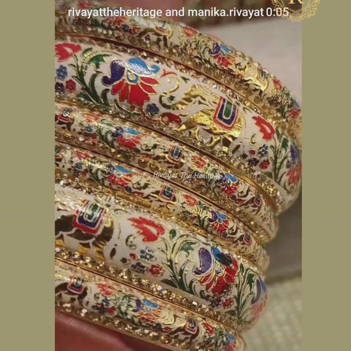 Video showcasing handcrafted ivory Meenakari bangles with peacock floral enamel work and stone-studded borders from Rivayat The Heritage